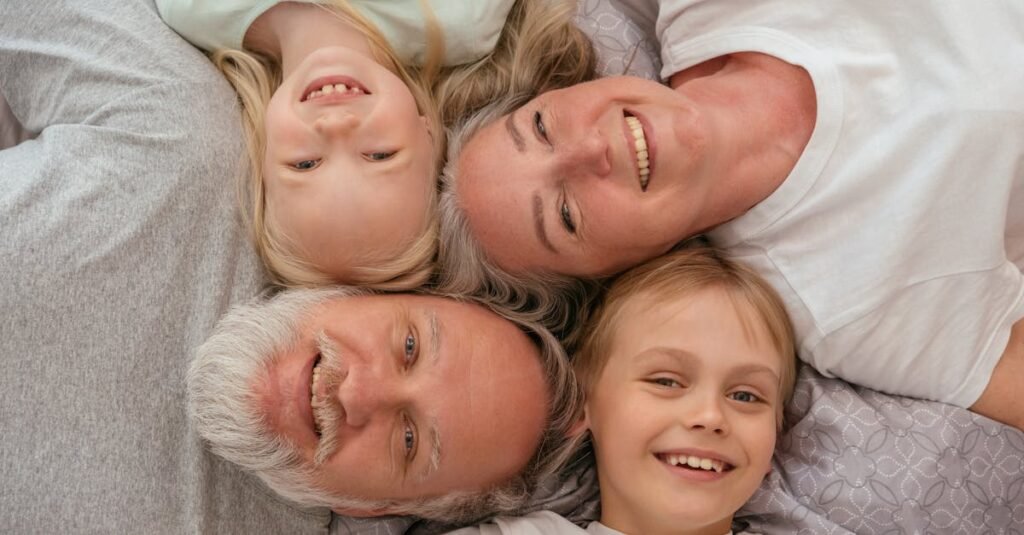 pexels-photo-8317785-8317785 A joyful multigenerational family lying down and smiling together, displaying warmth and affection.